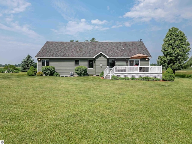6375 S Isabella Rd, Shepherd, MI 48883 - rear view of house featuring a wooden deck, a lawn, and a shingled roof