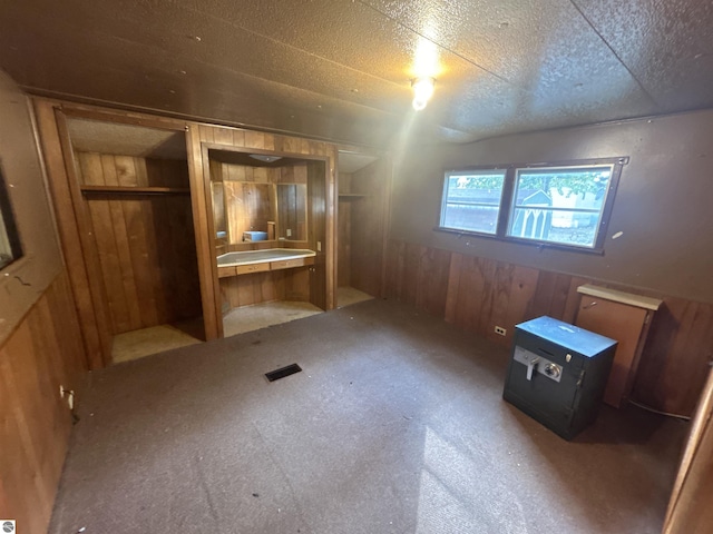 832 Manor Ln, Traverse City, MI 49686 - unfurnished bedroom with wooden walls and carpet
