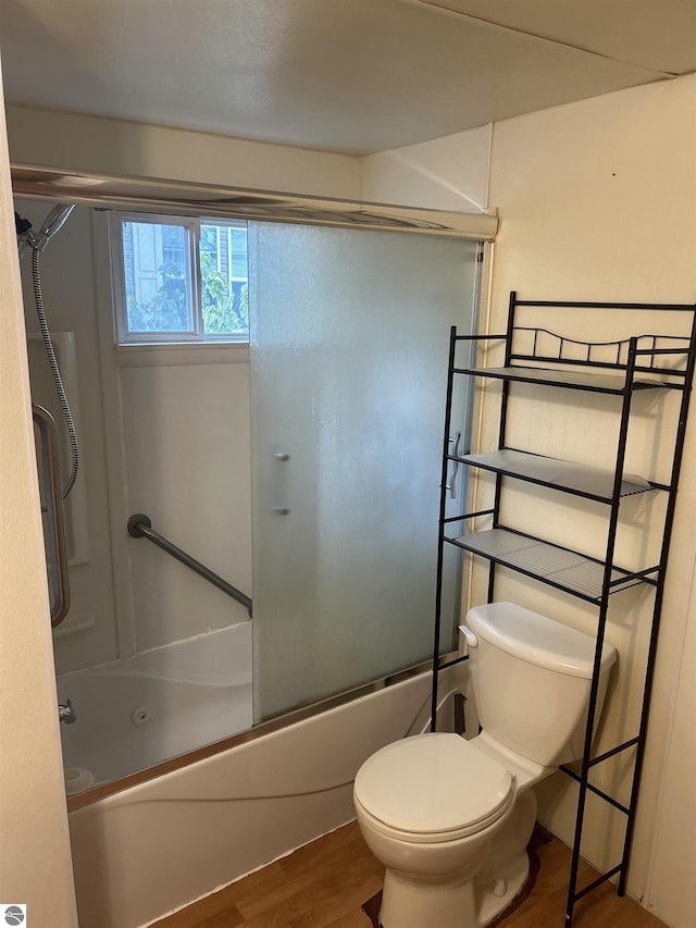 832 Manor Ln, Traverse City, MI 49686 - bathroom featuring shower / bath combination with glass door and wood finished floors