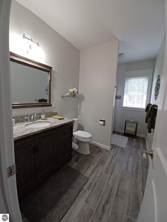 1379 Kunze Rd, East Tawas, MI 48730 - full bath with vanity, a shower, and wood finished floors
