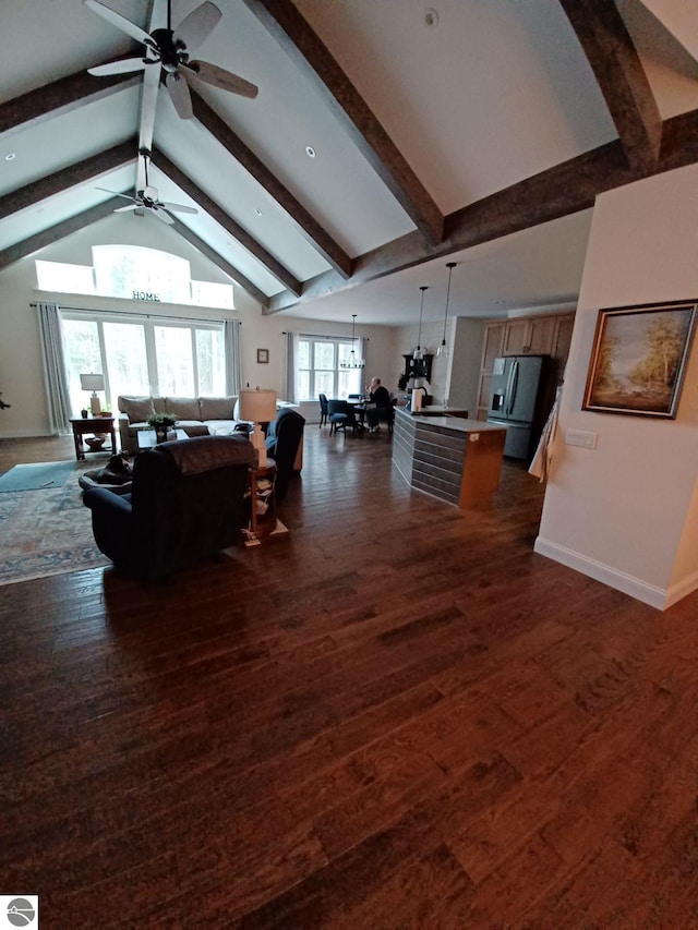 1379 Kunze Rd, East Tawas, MI 48730 - living room with ceiling fan, beam ceiling, dark wood-style floors, and high vaulted ceiling
