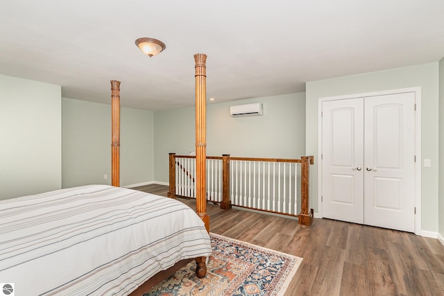 1379 Kunze Rd, East Tawas, MI 48730 - bedroom featuring wood finished floors, a wall mounted air conditioner, and a closet