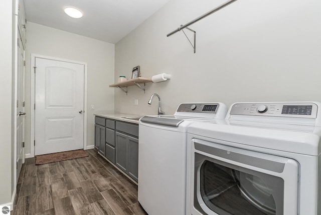 1379 Kunze Rd, East Tawas, MI 48730 - laundry area with cabinet space, independent washer and dryer, and dark wood finished floors