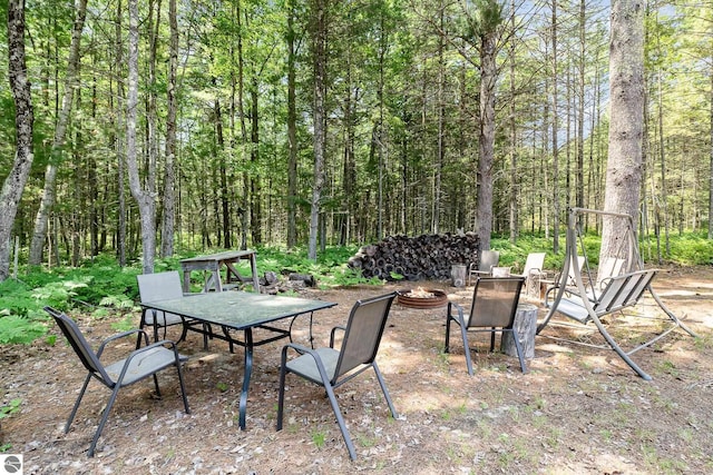 1379 Kunze Rd, East Tawas, MI 48730 - view of patio / terrace featuring an outdoor fire pit and a view of trees