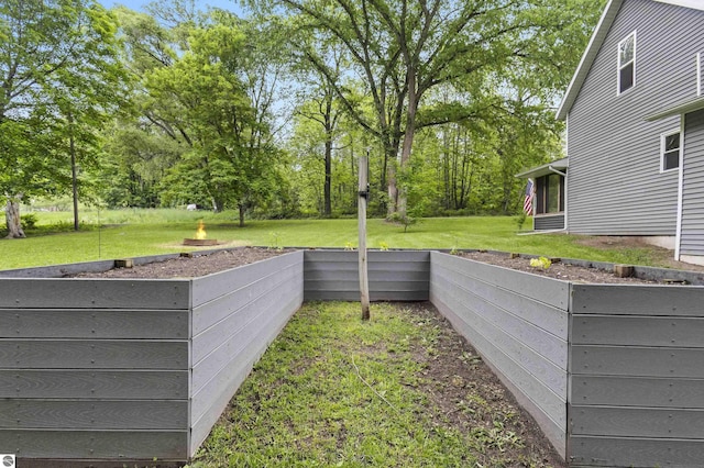 16933 3rd St, Copemish, MI 49625 - view of green lawn with a garden and view of wooded area