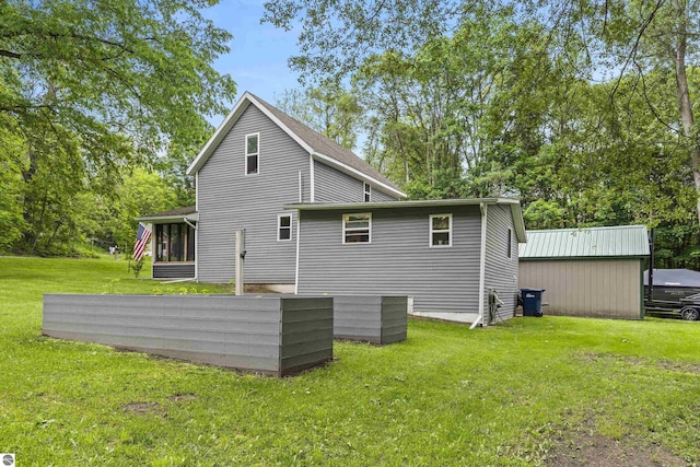 16933 3rd St, Copemish, MI 49625 - back of property with a lawn and a sunroom