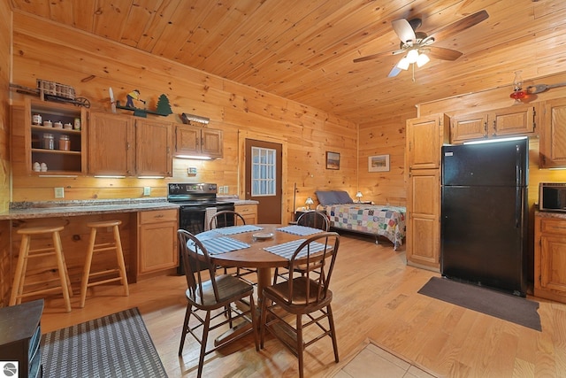 405 E Shetland Trl, Cedar, MI 49621 - dining space with wood walls, wooden ceiling, light wood-style floors, and a ceiling fan