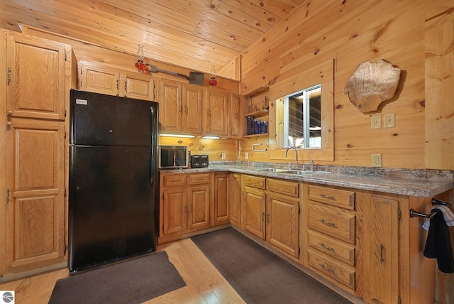 405 E Shetland Trl, Cedar, MI 49621 - kitchen featuring freestanding refrigerator, wooden walls, light wood-style flooring, lofted ceiling, and wooden ceiling