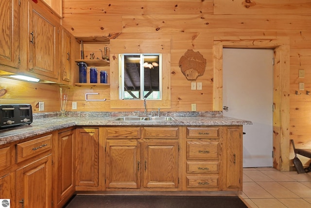 405 E Shetland Trl, Cedar, MI 49621 - kitchen featuring wooden walls, light tile patterned flooring, brown cabinetry, and open shelves