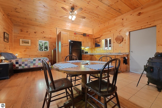 405 E Shetland Trl, Cedar, MI 49621 - dining space with wood walls, a ceiling fan, wooden ceiling, and light tile patterned floors