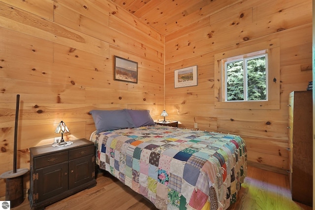 405 E Shetland Trl, Cedar, MI 49621 - bedroom with light wood finished floors and wood walls