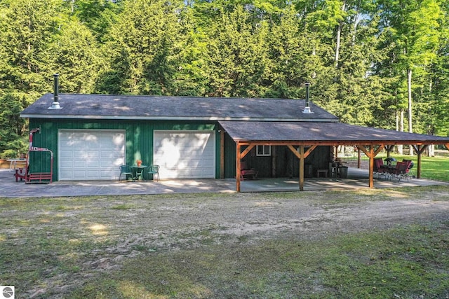 405 E Shetland Trl, Cedar, MI 49621 - garage featuring a detached garage and a forest view