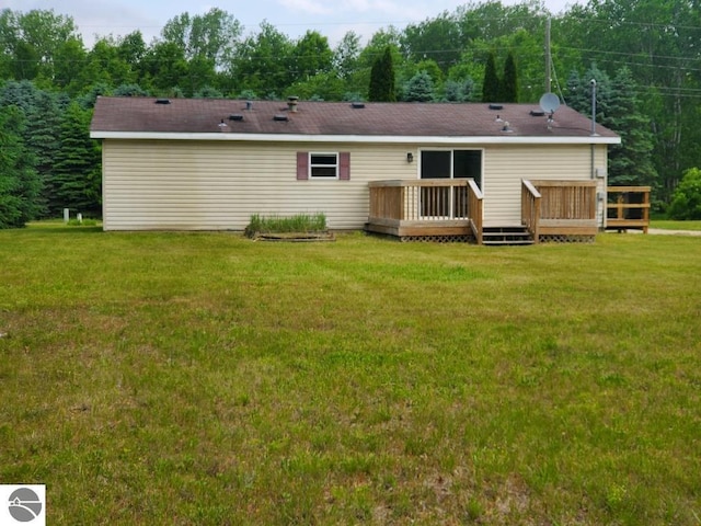5819 Indian Ln, Weidman, MI 48893 - back of property featuring a lawn and a deck