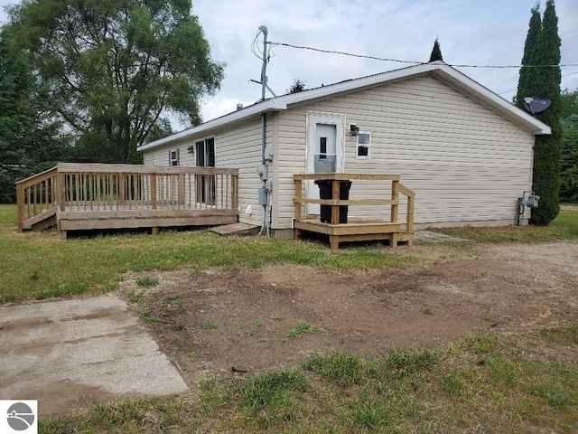 5819 Indian Ln, Weidman, MI 48893 - back of property with a wooden deck