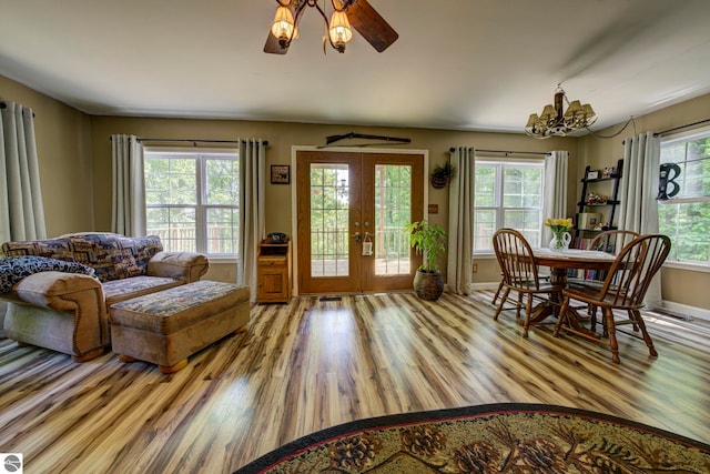 3721 W 18th Rd, Mesick, MI 49668 - living area with a chandelier, light wood-style floors, french doors, and a ceiling fan