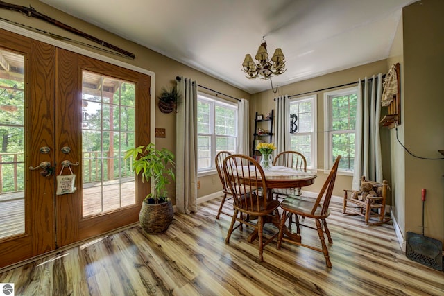 3721 W 18th Rd, Mesick, MI 49668 - dining space with a chandelier and light wood-style floors