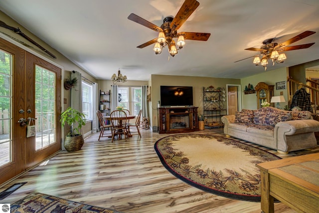 3721 W 18th Rd, Mesick, MI 49668 - living area featuring ceiling fan, light wood-style floors, a fireplace, and french doors