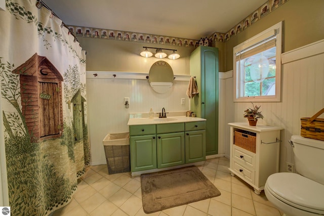 3721 W 18th Rd, Mesick, MI 49668 - bathroom featuring vanity, tile patterned floors, and a wainscoted wall