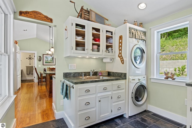 1740 Setterbo Rd, Suttons Bay, MI 49682 - laundry room with stacked washer / dryer, cabinet space, and recessed lighting