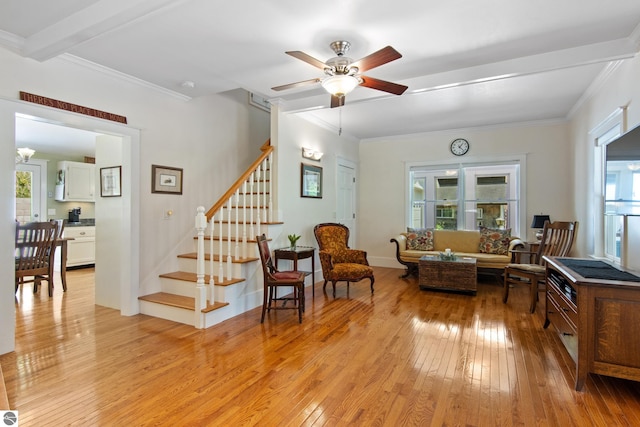 1740 Setterbo Rd, Suttons Bay, MI 49682 - living area featuring light wood-style floors, stairway, ceiling fan, and ornamental molding