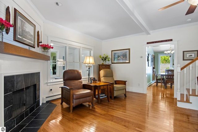 1740 Setterbo Rd, Suttons Bay, MI 49682 - sitting room with light wood finished floors, baseboard heating, a fireplace, a ceiling fan, and ornamental molding
