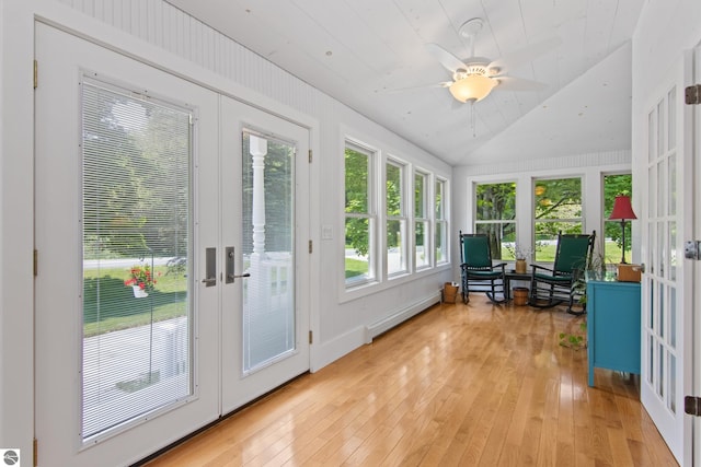 1740 Setterbo Rd, Suttons Bay, MI 49682 - sunroom with french doors, a baseboard radiator, wood-type flooring, lofted ceiling, and a wooden deck