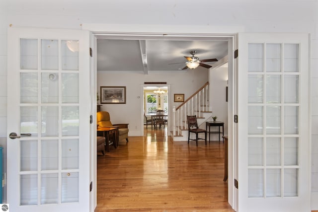 1740 Setterbo Rd, Suttons Bay, MI 49682 - entrance foyer with light wood-type flooring, stairway, a chandelier, a ceiling fan, and french doors