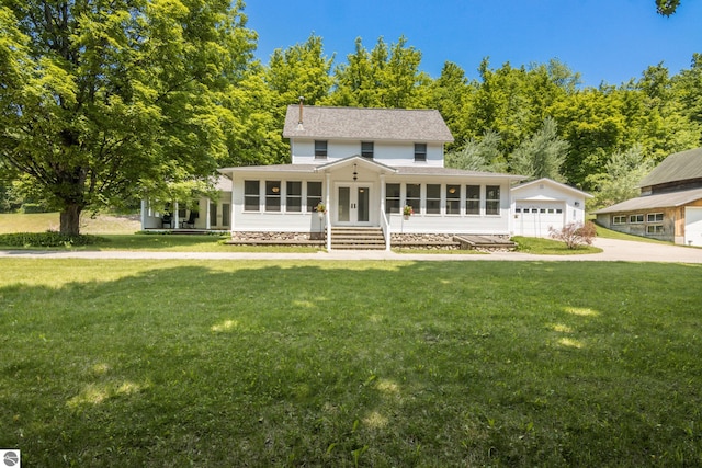 1740 Setterbo Rd, Suttons Bay, MI 49682 - view of front of property featuring a sunroom, french doors, a front yard, and concrete driveway