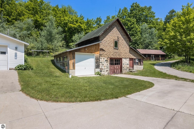 1740 Setterbo Rd, Suttons Bay, MI 49682 - view of front facade featuring a front lawn, a garage, stone siding, and driveway
