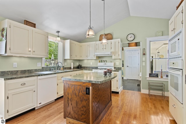 1740 Setterbo Rd, Suttons Bay, MI 49682 - kitchen featuring white appliances, under cabinet range hood, lofted ceiling, a kitchen island, and dark countertops