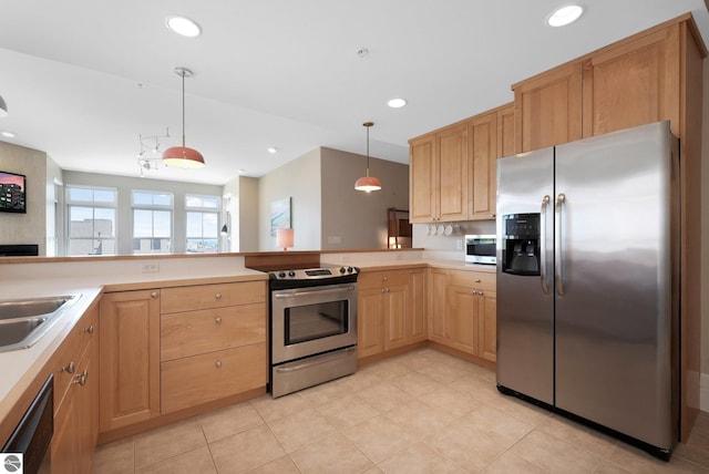 141 Rivers Edge Dr Unit 310, Traverse City, MI 49684 - kitchen featuring appliances with stainless steel finishes, light brown cabinets, hanging light fixtures, light countertops, and recessed lighting