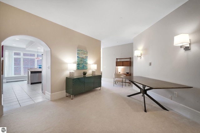141 Rivers Edge Dr Unit 310, Traverse City, MI 49684 - hall with arched walkways, light colored carpet, and a baseboard heating unit
