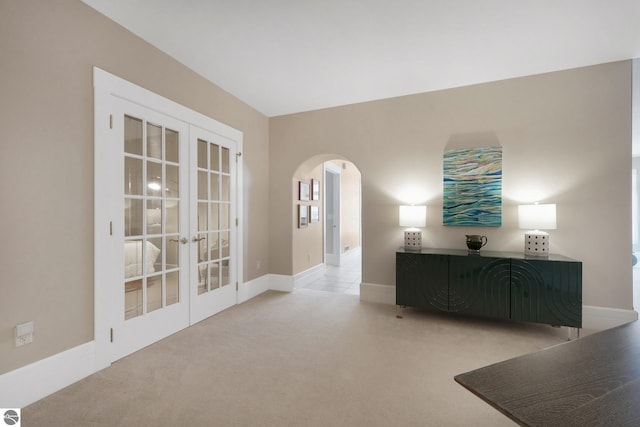 141 Rivers Edge Dr Unit 310, Traverse City, MI 49684 - spare room with carpet floors, arched walkways, and french doors