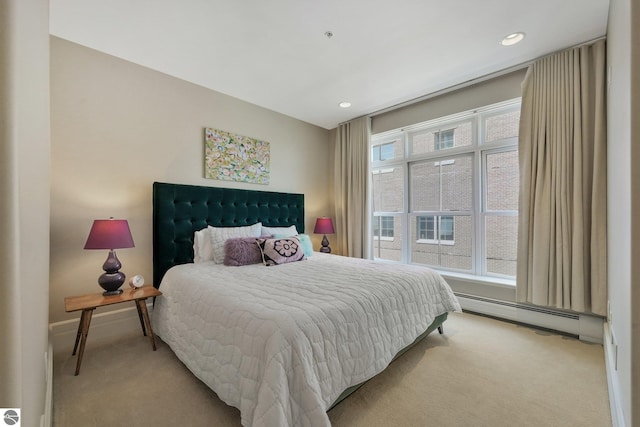 141 Rivers Edge Dr Unit 310, Traverse City, MI 49684 - bedroom featuring light carpet, a baseboard radiator, and recessed lighting