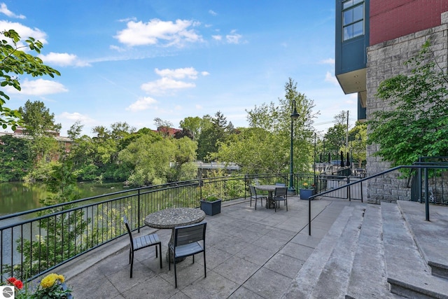 141 Rivers Edge Dr Unit 310, Traverse City, MI 49684 - view of patio featuring outdoor dining space and a water view