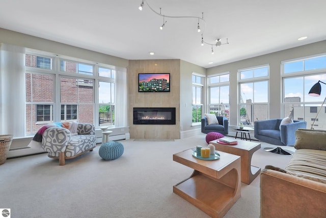 141 Rivers Edge Dr Unit 310, Traverse City, MI 49684 - living area featuring a tile fireplace, healthy amount of natural light, carpet flooring, recessed lighting, and baseboard heating