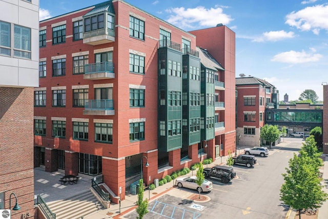 141 Rivers Edge Dr Unit 310, Traverse City, MI 49684 - view of apartment building / complex featuring uncovered parking