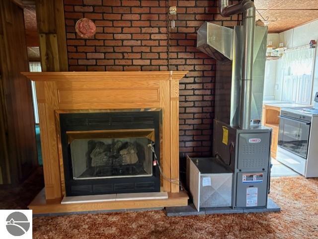 4161 Elbow Lake Rd, Prescott, MI 48756 - detailed view of range, a fireplace, and brick wall