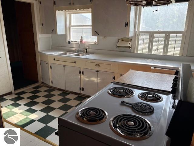 4161 Elbow Lake Rd, Prescott, MI 48756 - kitchen featuring light floors, electric stove, and light countertops