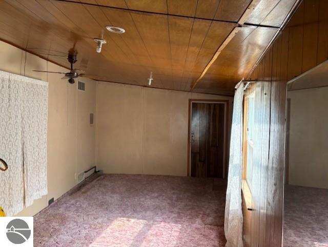 4161 Elbow Lake Rd, Prescott, MI 48756 - unfurnished room featuring carpet floors, a ceiling fan, and wood ceiling