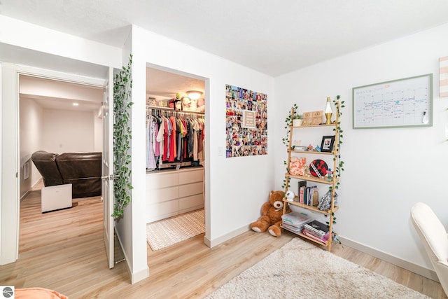3468 Kali Ln, Alma, MI 48801 - bedroom featuring light wood-type flooring, a spacious closet, and a closet
