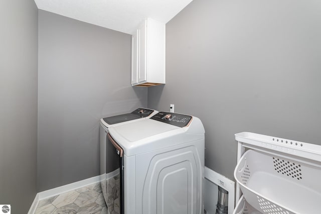 3468 Kali Ln, Alma, MI 48801 - laundry room featuring cabinet space, washer and clothes dryer, and light marble finish flooring