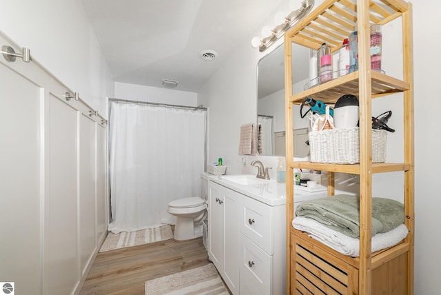 3468 Kali Ln, Alma, MI 48801 - full bath featuring wood finished floors, vanity, and a shower with shower curtain