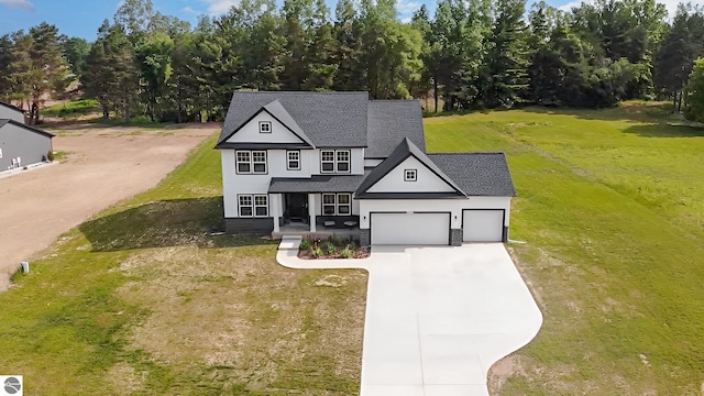 3468 Kali Ln, Alma, MI 48801 - view of front of house featuring concrete driveway, an attached garage, a front lawn, a porch, and a shingled roof