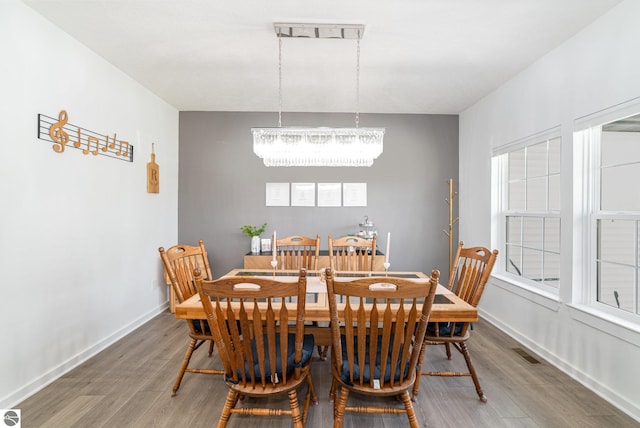 3468 Kali Ln, Alma, MI 48801 - dining room featuring a chandelier, wood finished floors, and healthy amount of natural light
