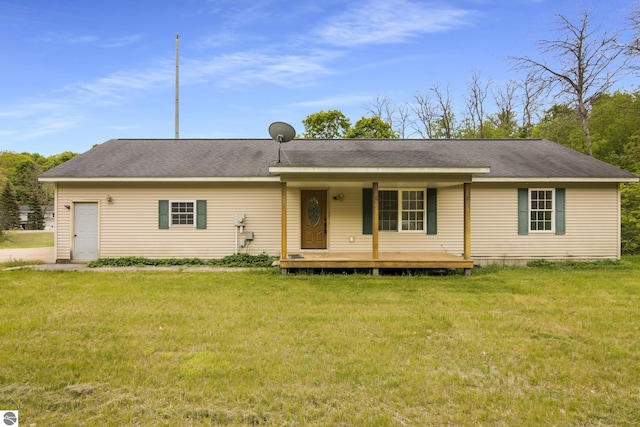 2733 Windcrest Ln, Traverse City, MI 49686 - single story home with a front yard, a porch, and a shingled roof