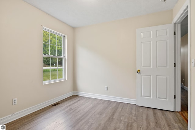 2733 Windcrest Ln, Traverse City, MI 49686 - unfurnished bedroom with wood finished floors