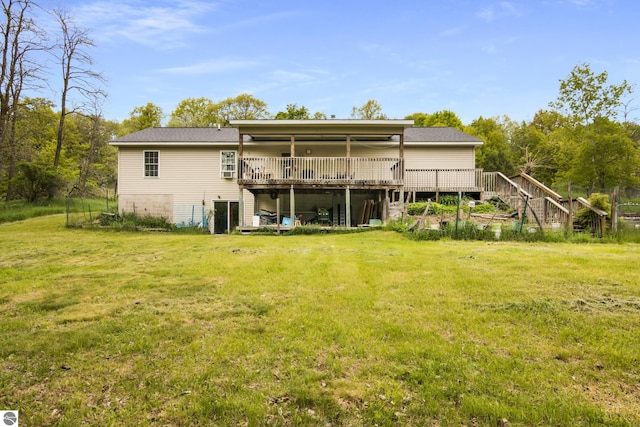2733 Windcrest Ln, Traverse City, MI 49686 - rear view of property with a wooden deck, a lawn, and stairway