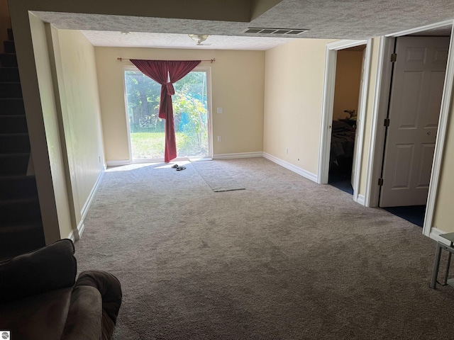2733 Windcrest Ln, Traverse City, MI 49686 - unfurnished living room with carpet flooring and a textured ceiling