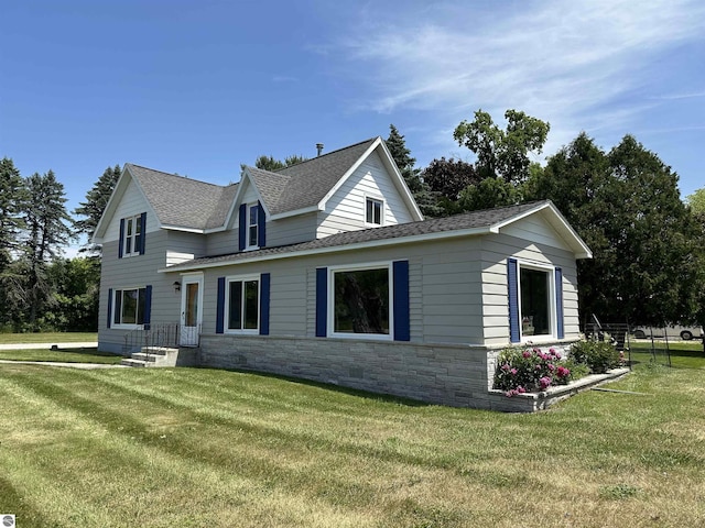 1339 S Melita Rd, Sterling, MI 48659 - view of property exterior featuring roof with shingles, a yard, and stone siding